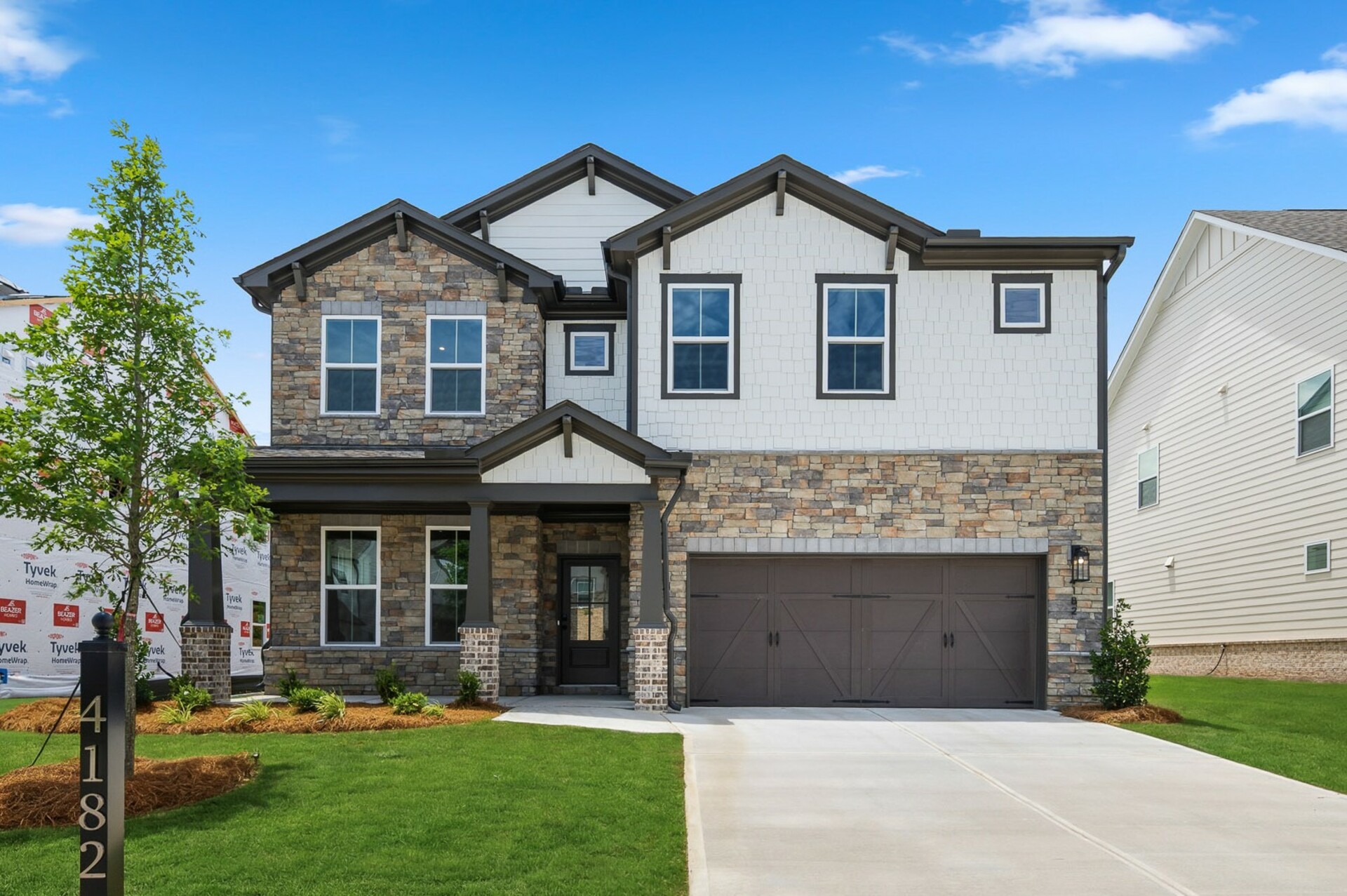 front if 2-story single-family homes with white siding and dark accents