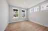 bedroom with windows and hard surface flooring
