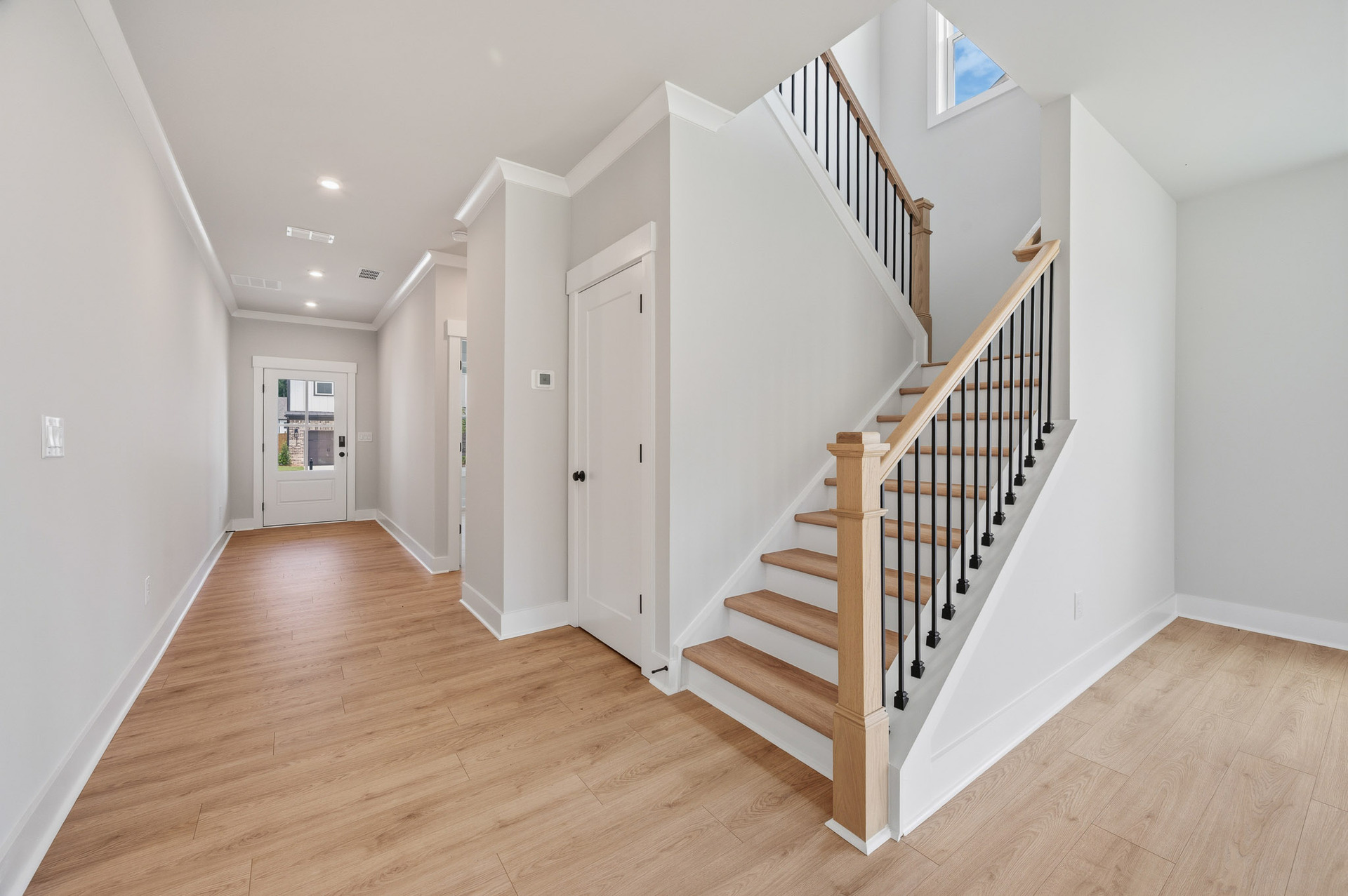 foyer with hard surface flooring & staircase