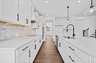 kitchen with large center island and white cabinets