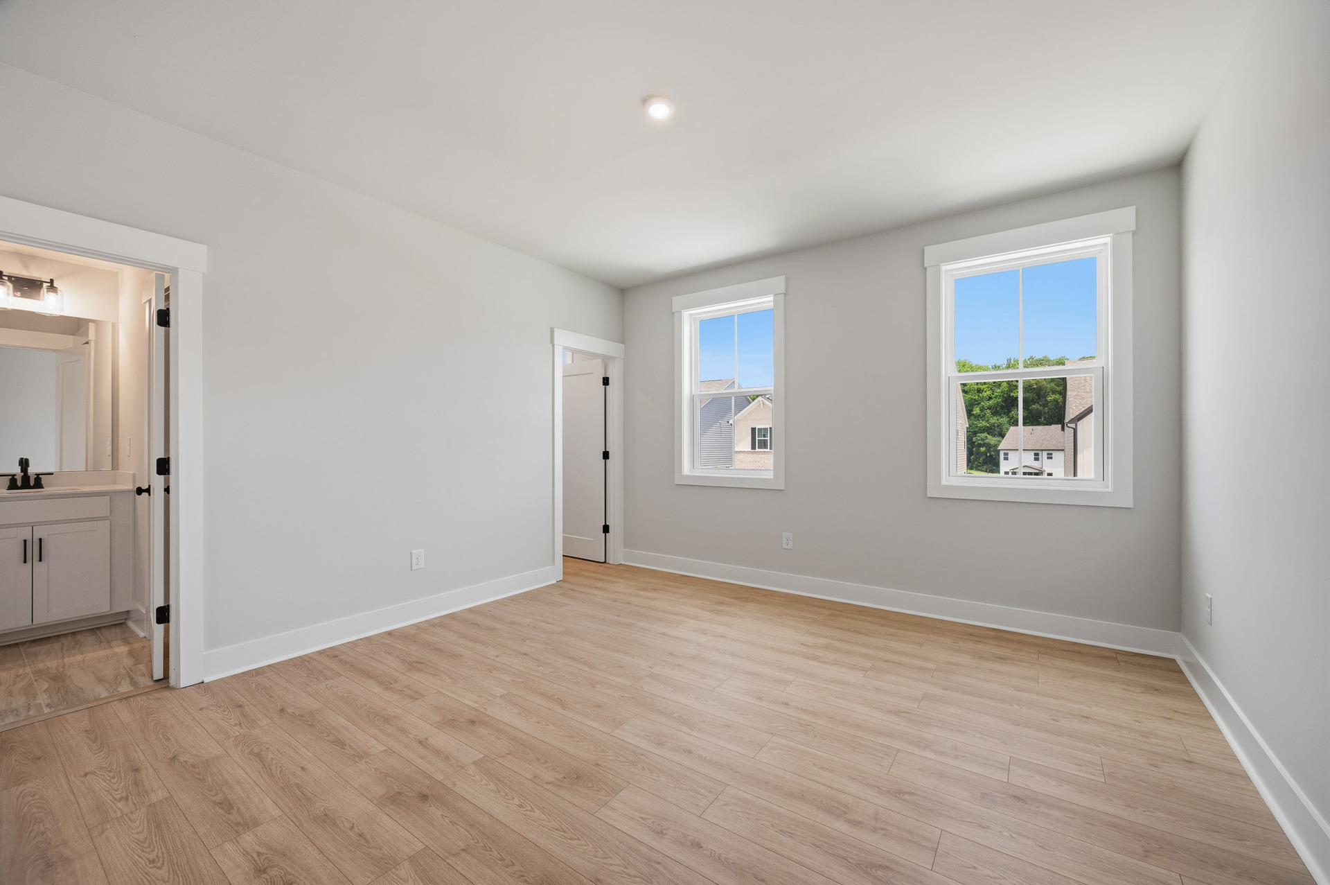 bedroom with windows and hard-surface flooring