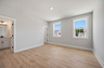 bedroom with windows and hard-surface flooring