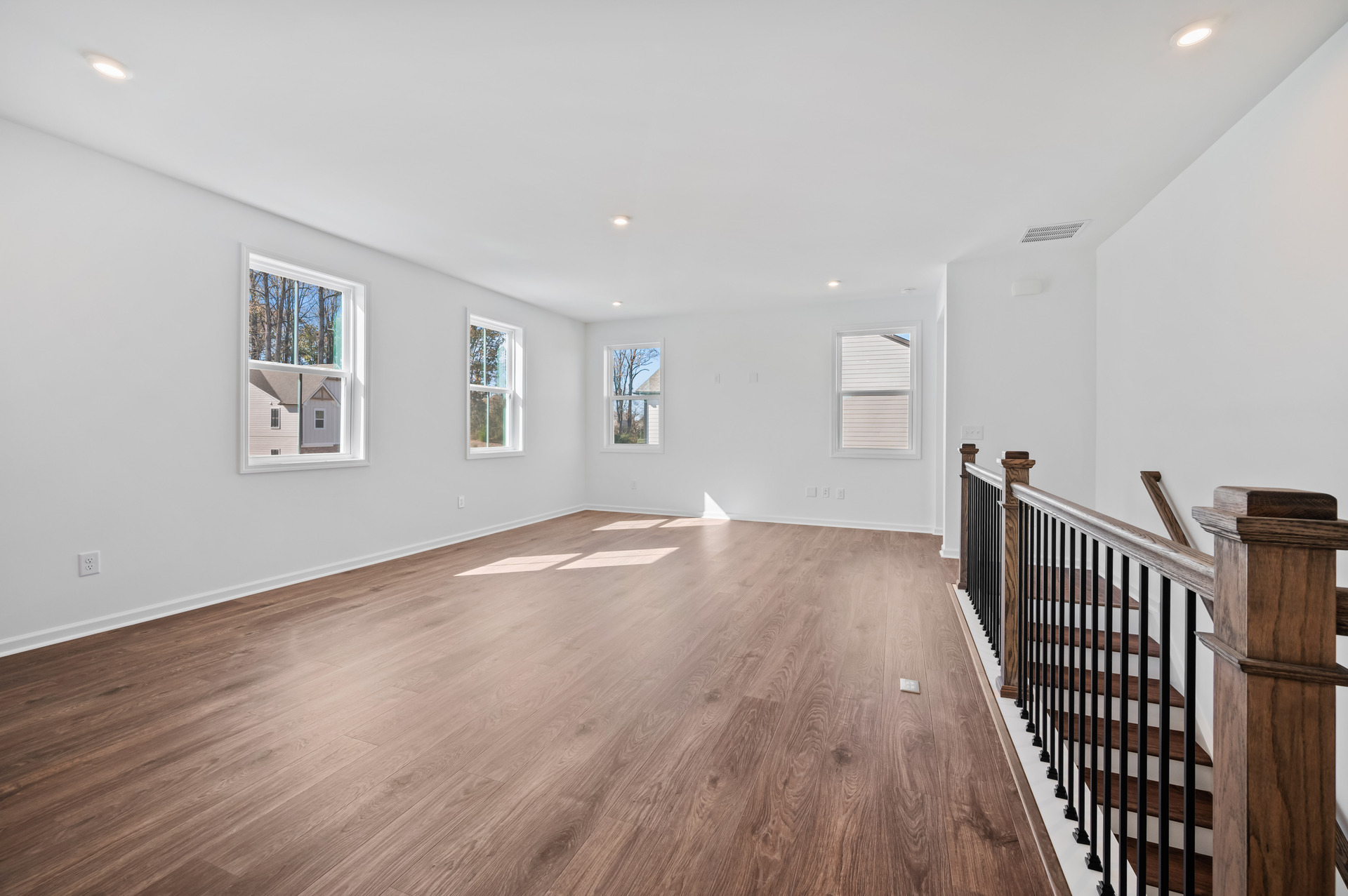 loft with hard-surface flooring and windows
