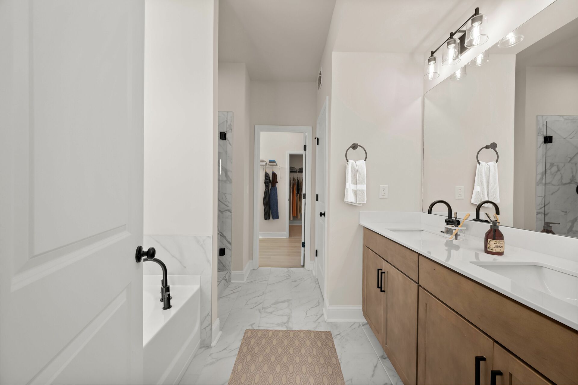 primary bathroom with dual vanity and wood-finish cabinets