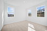 secondary bedroom with windows and carpet