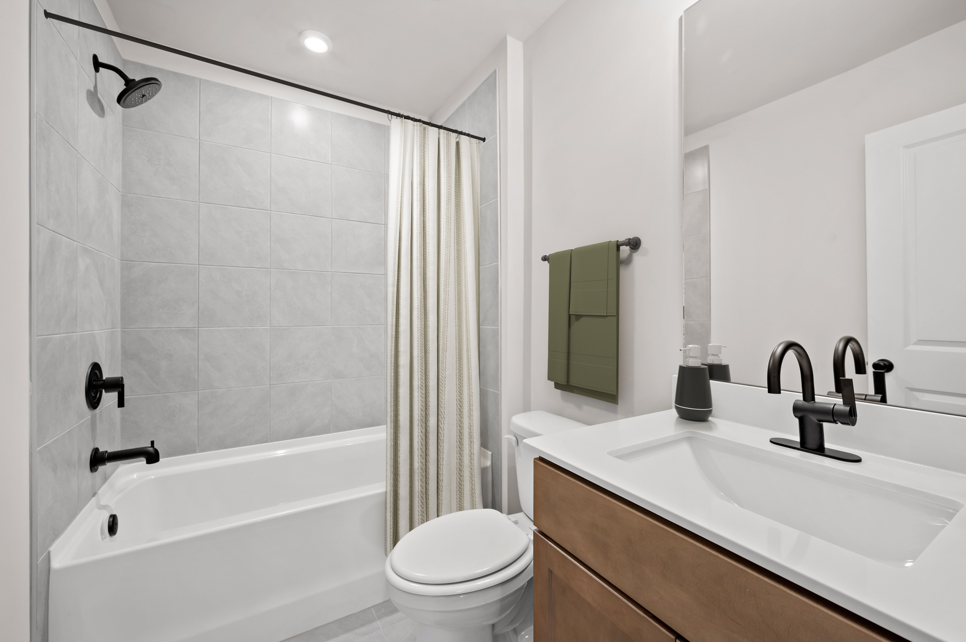 secondary bathroom with vanity and wood-finish cabinets