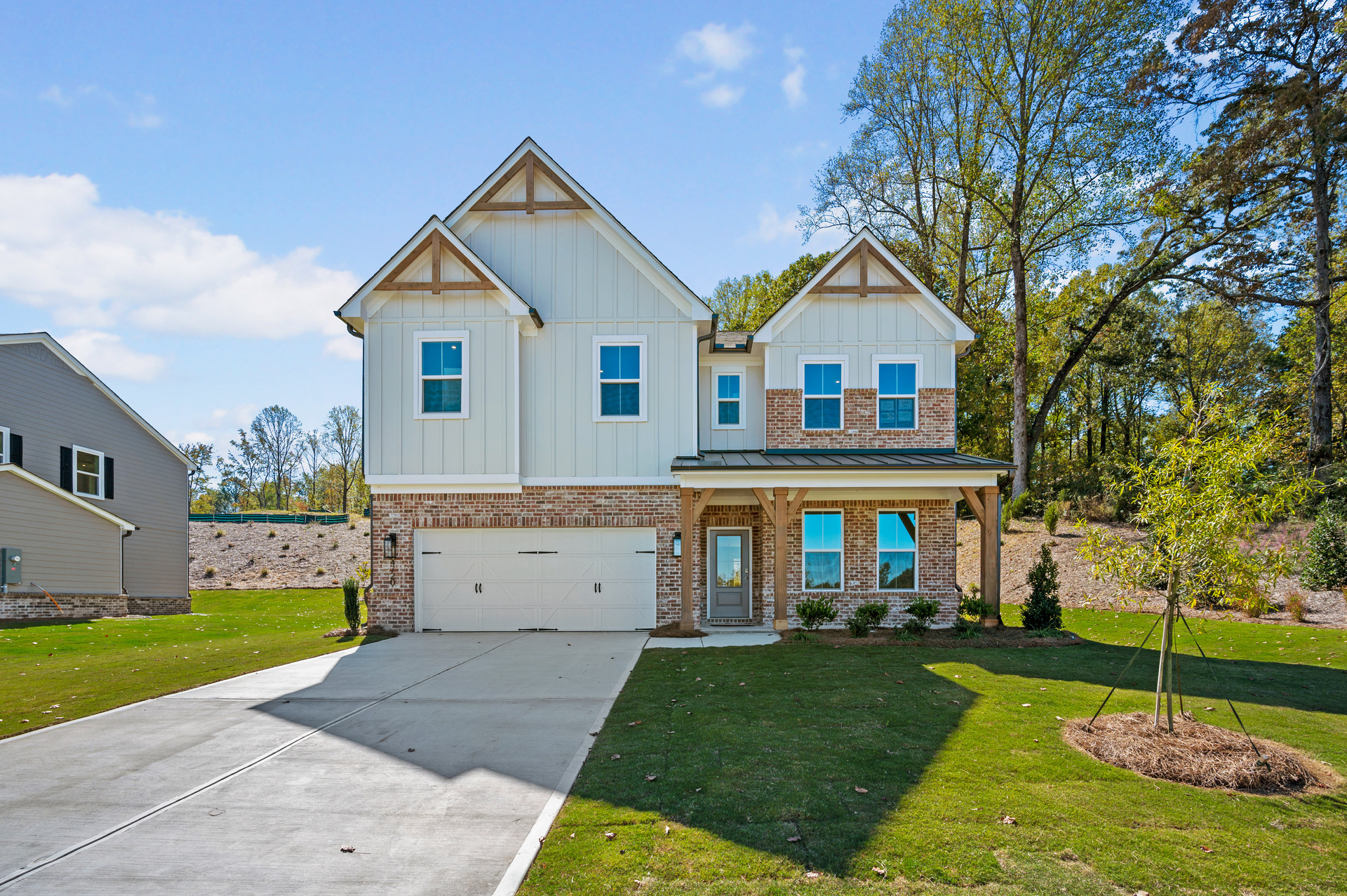front of 2-story home with brick and light siding