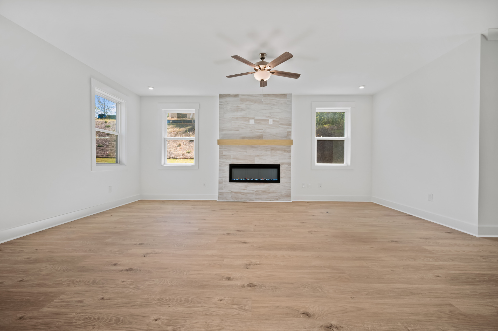 great room with electric fireplace and hard-surface flooring