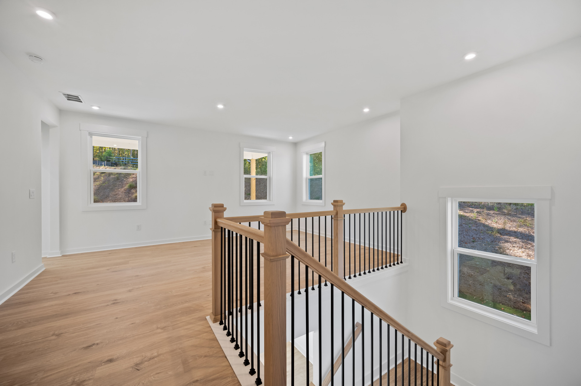 loft with hard-surface flooring and windows