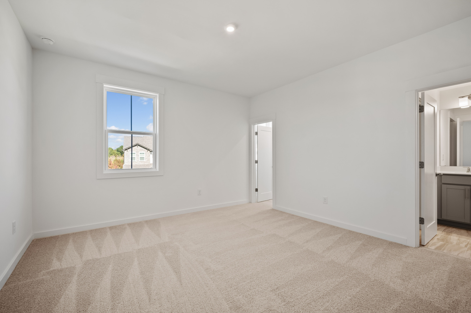 secondary bedroom with carpet and attached bath