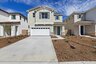 cream colored two-story exterior with a white windowed garage