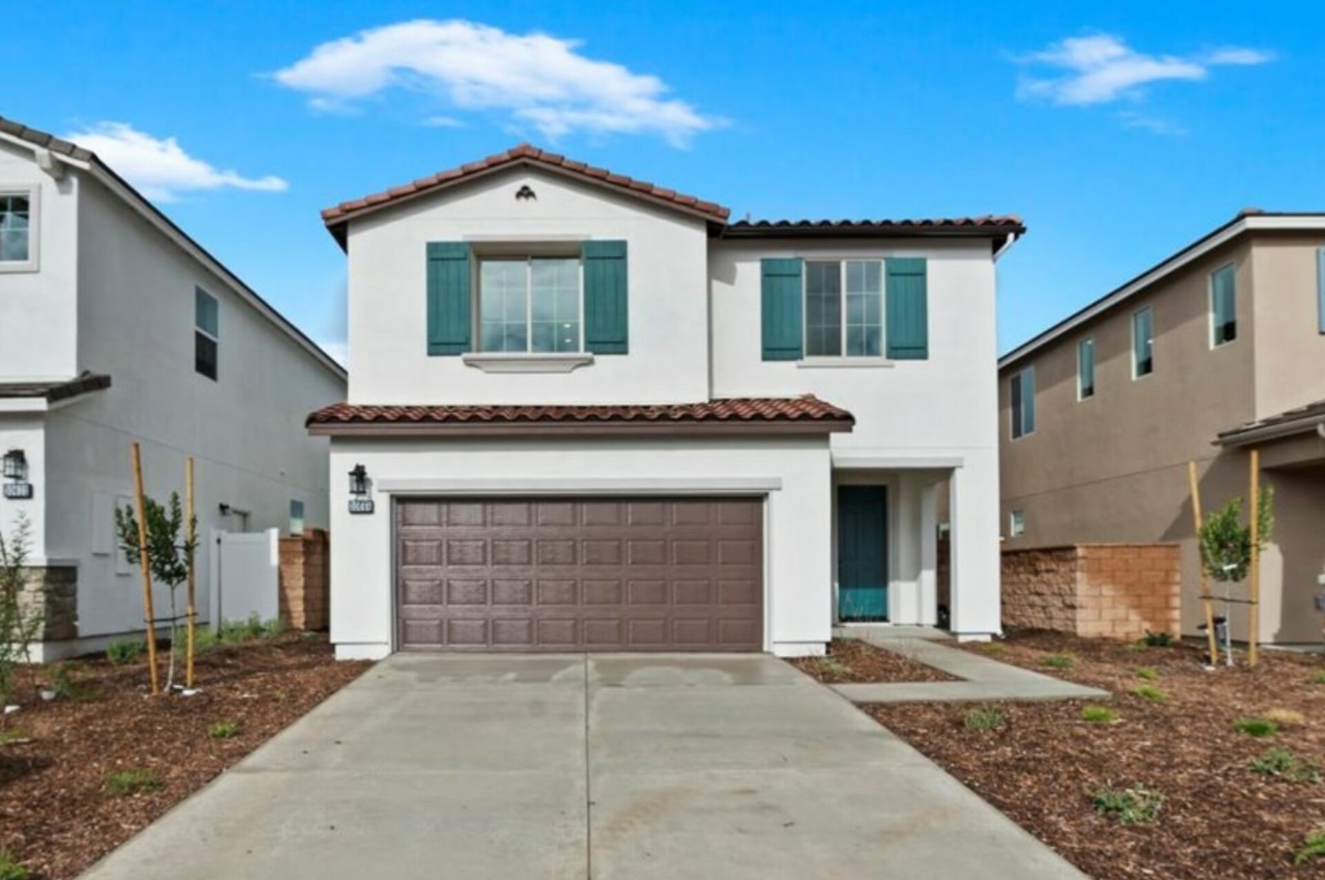 exterior of two-story home with large windows and brown garage