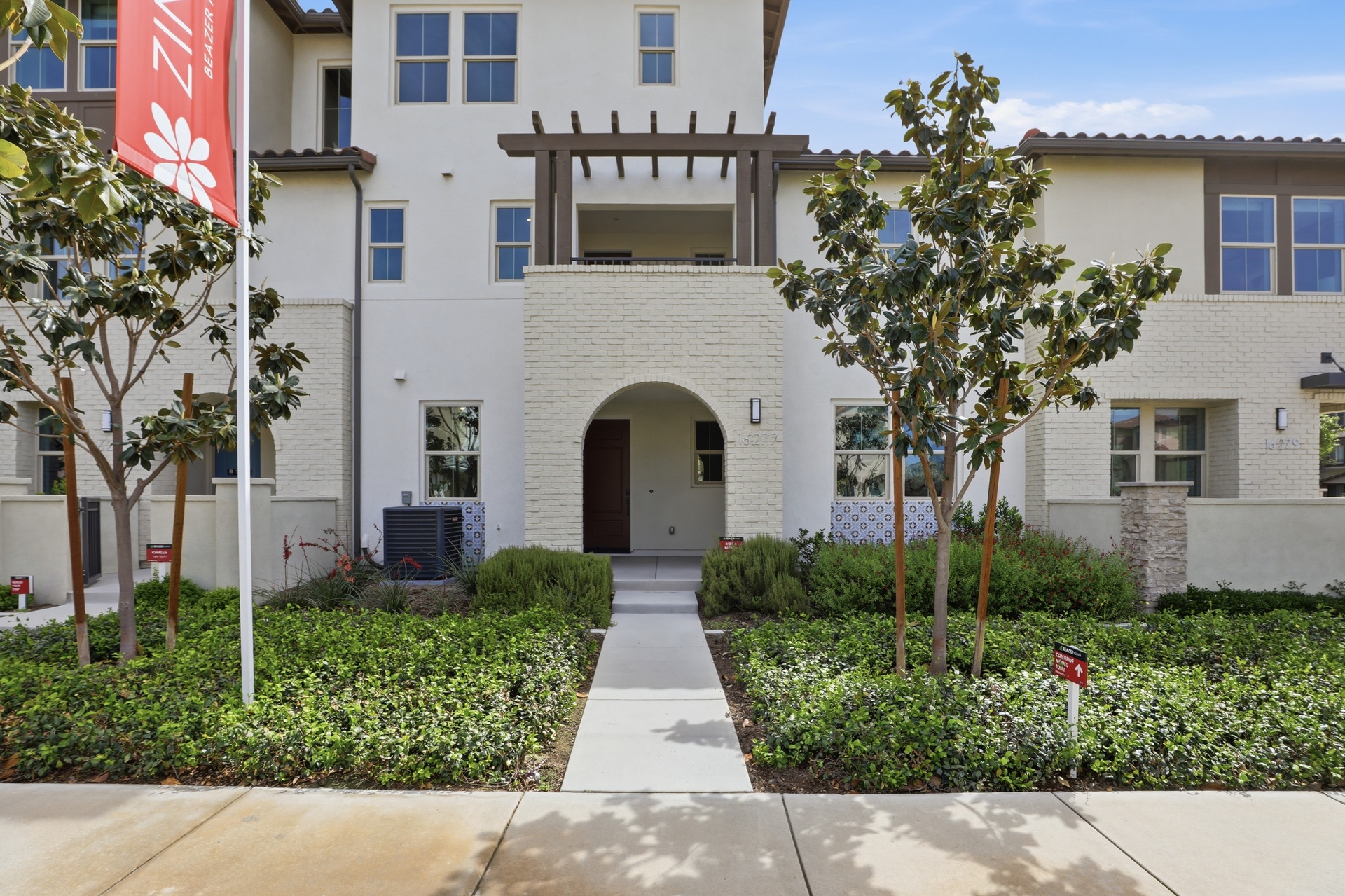 exterior of townhome with neutral paint and balcony