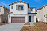 two-story exterior with a brown windowless garage and three windows