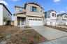 exterior of two-story home with neutral paint and white garage