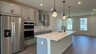 kitchen with gray cabinets and stainless steel appliances