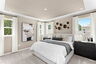 large bed with dresser and artwork