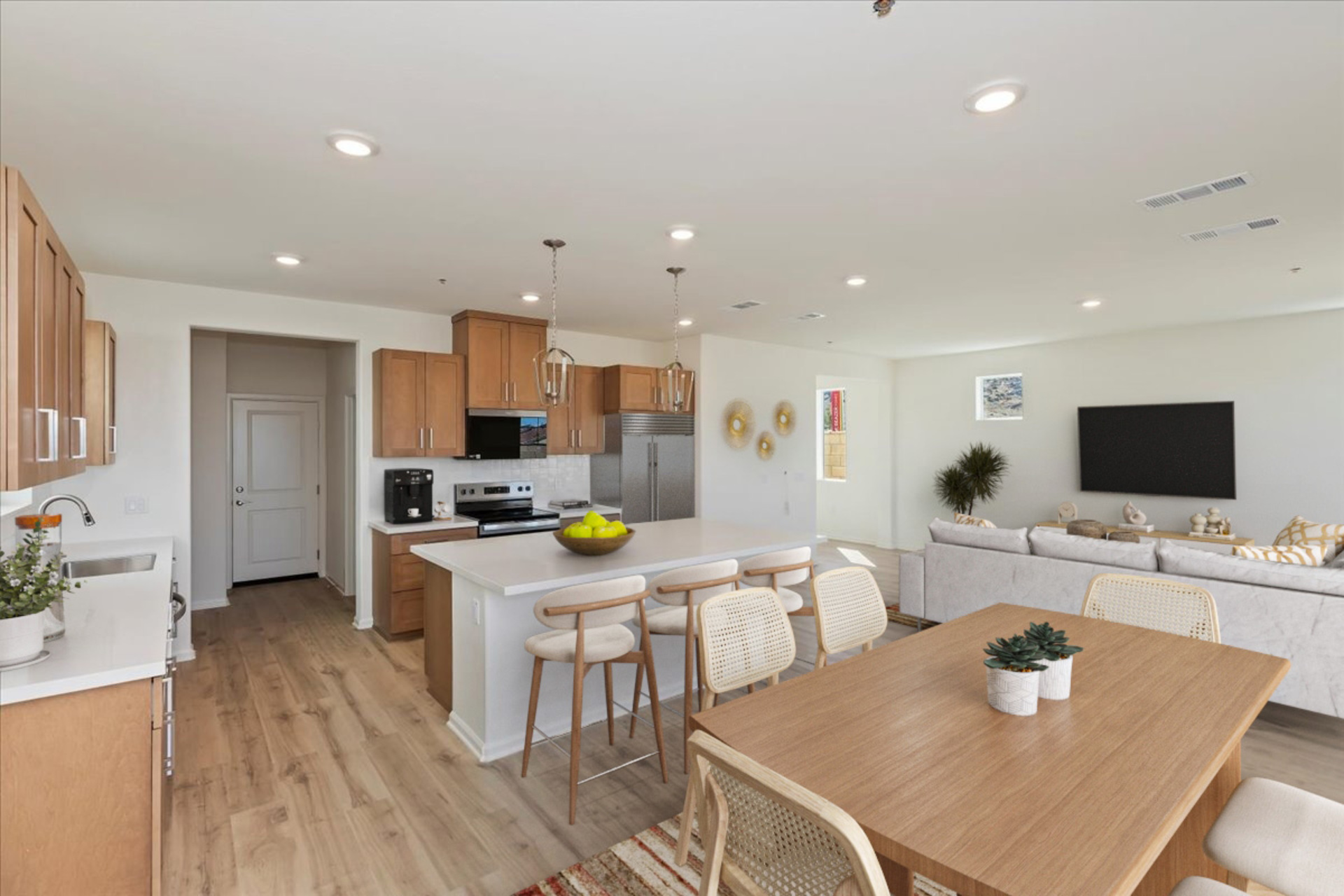 dining room table with wicker chairs and kitchen in the background