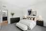 primary suite with large bed and cabinets