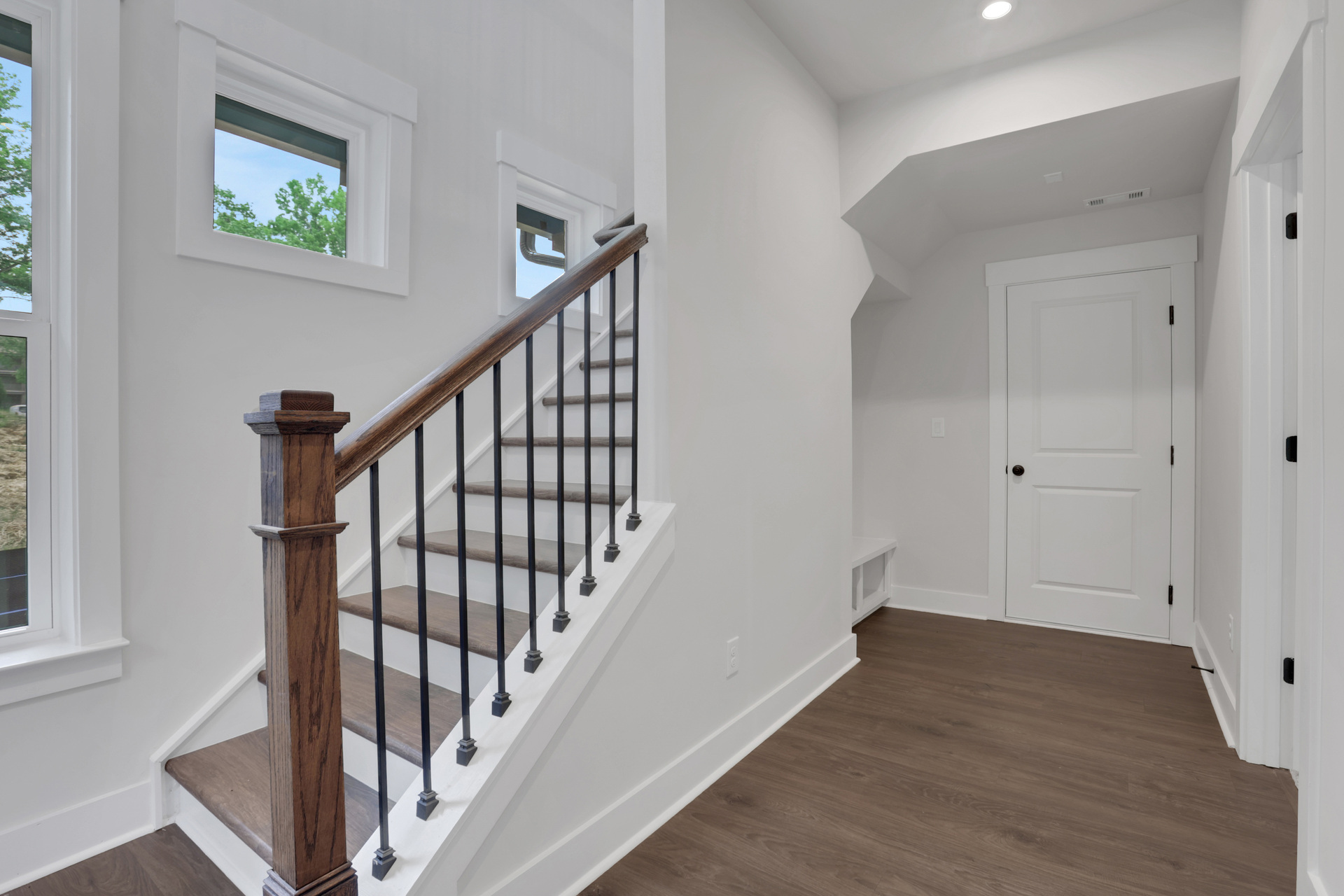 foyer with hard surface flooring and stairs