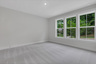 bedroom with windows and carpet