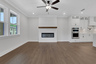 great room with shiplap fireplace and hard surface flooring