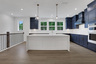kitchen with dark blue cabinets and white quartz counters