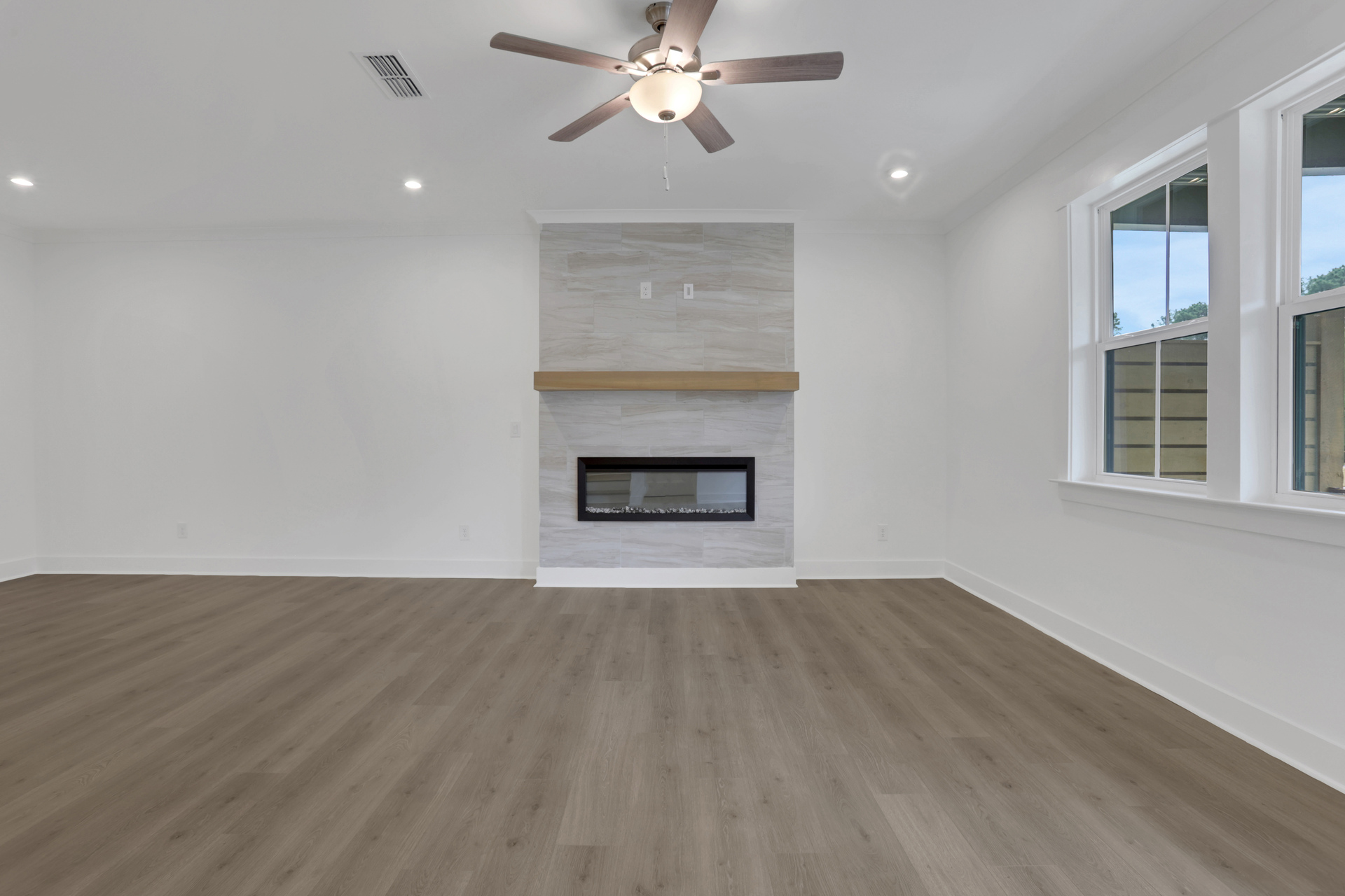 great room with electric fireplace and hard surface flooring