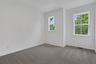 bedroom with windows and carpet