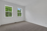 bedroom with windows and carpet