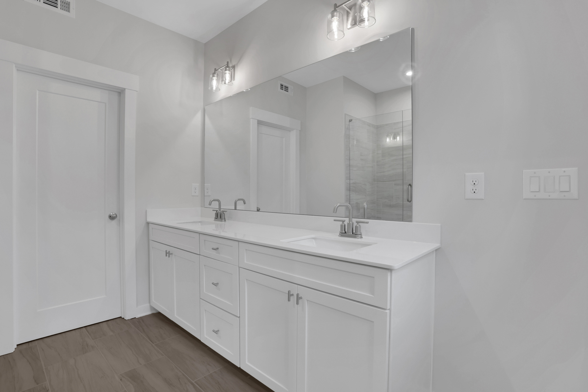 primary bathroom with white cabinets and tile flooring