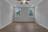 primary bedroom with windows and hard surface floors