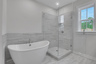 primary bathroom with separate soaker tub and walk-in shower