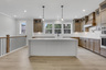 kitchen with wood-finish cabinets and quartz counters