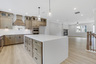 kitchen with wood-finish cabinets and quartz counters