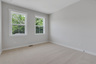 bedroom with windows and carpet