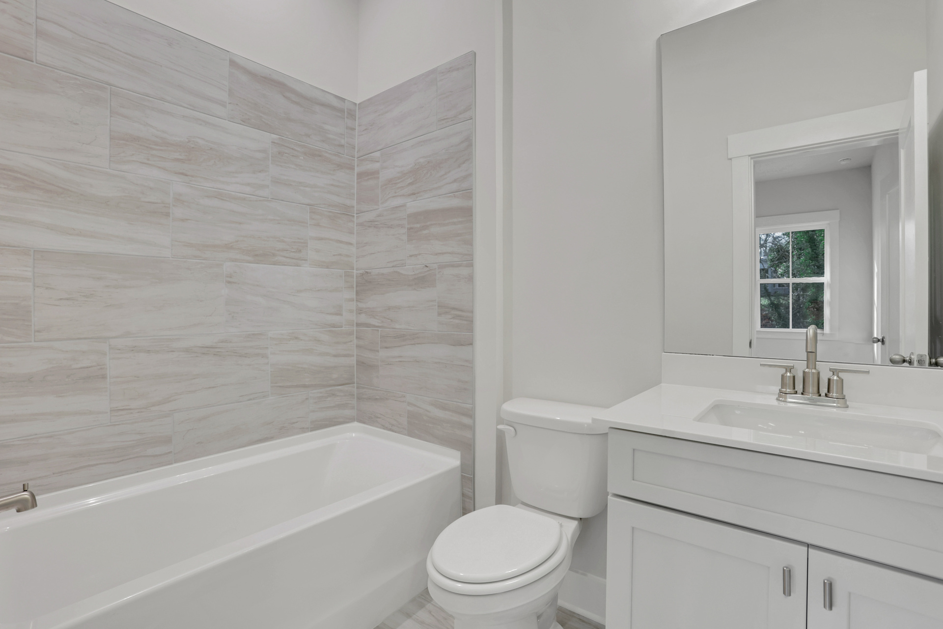 bathroom with white cabinets and shower/tub combo