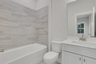 bathroom with white cabinets and shower/tub combo