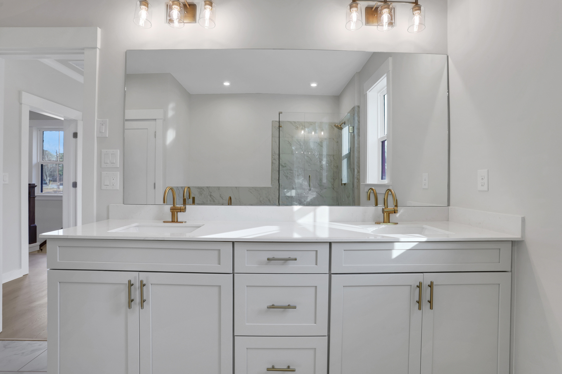 primary bathroom with white cabinets and white qartz counters