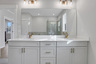 primary bathroom with white cabinets and white qartz counters