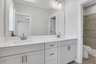 bathroom with white cabinets and separate water closet