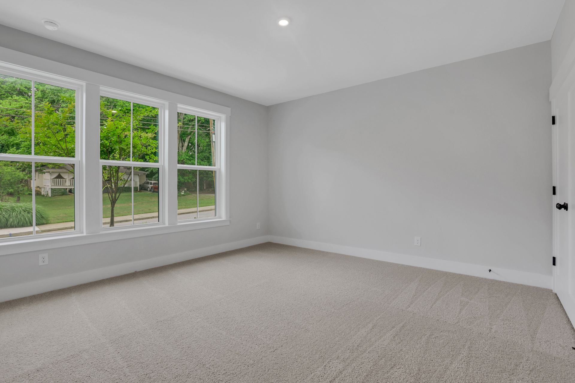 bedroom with windows and carpet
