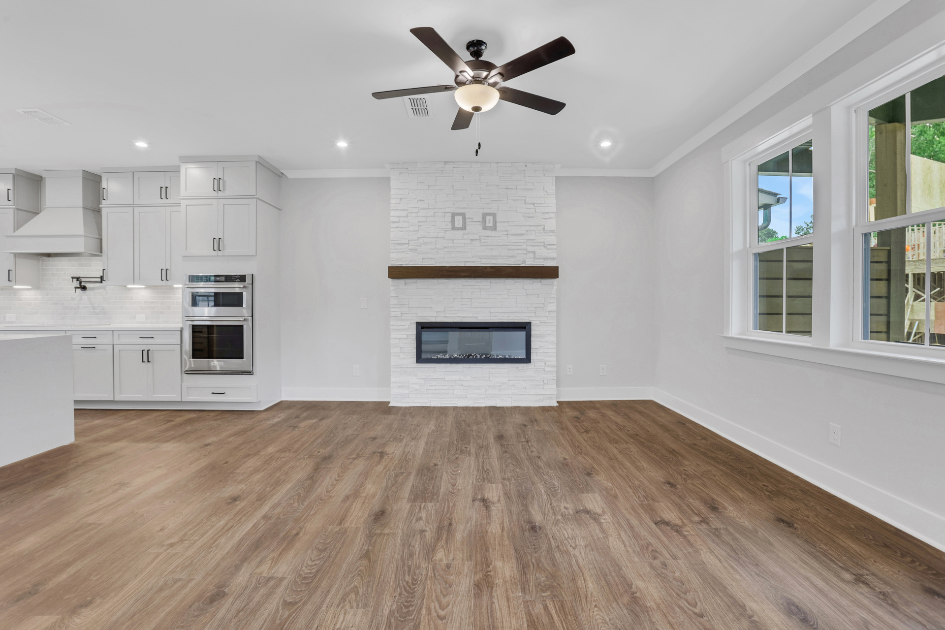 great room with electric fireplace and hard surface flooring