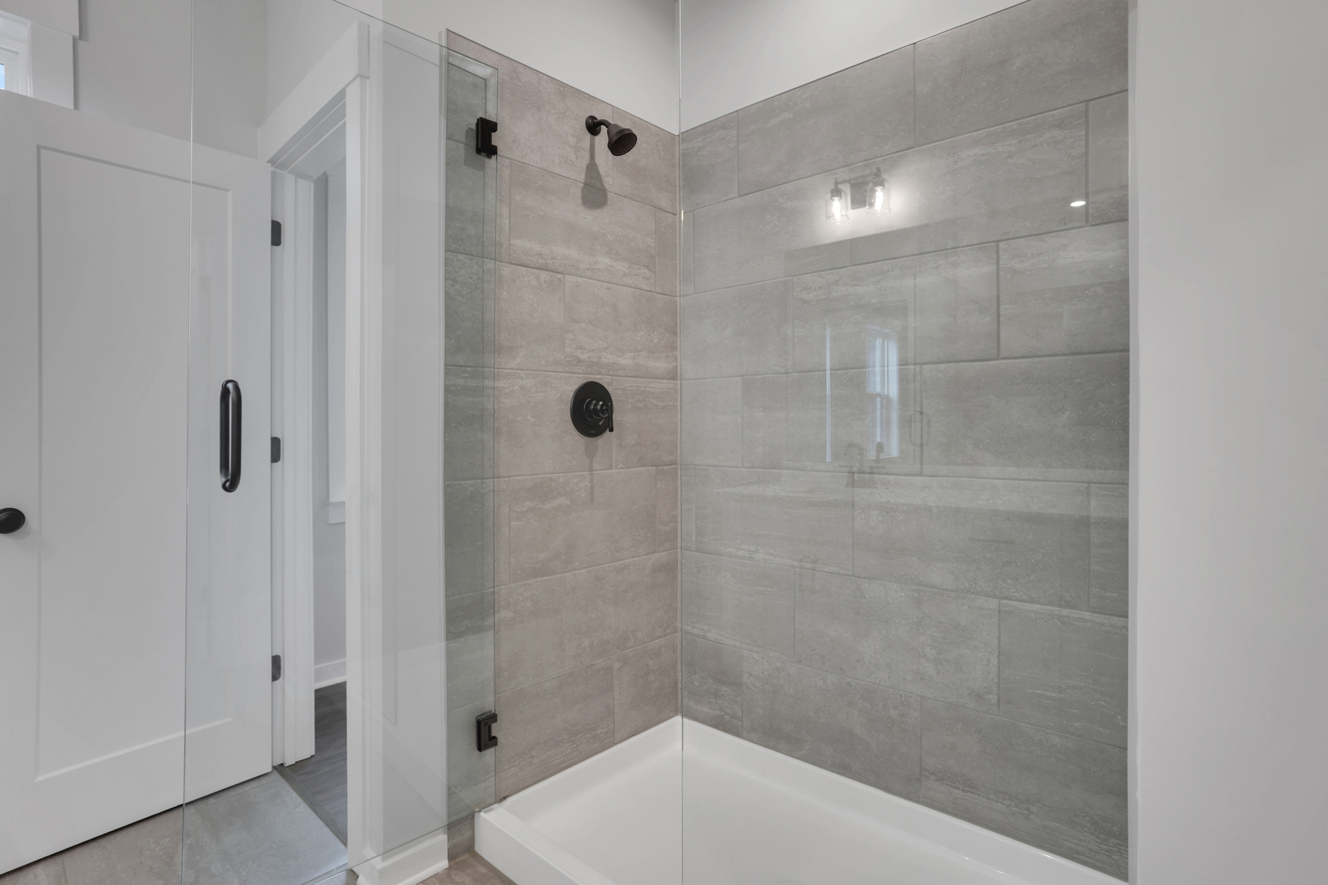 primary bathroom with walk-in shower and tile flooring