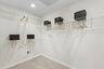 walk in closet with wired shelfing and coat racks