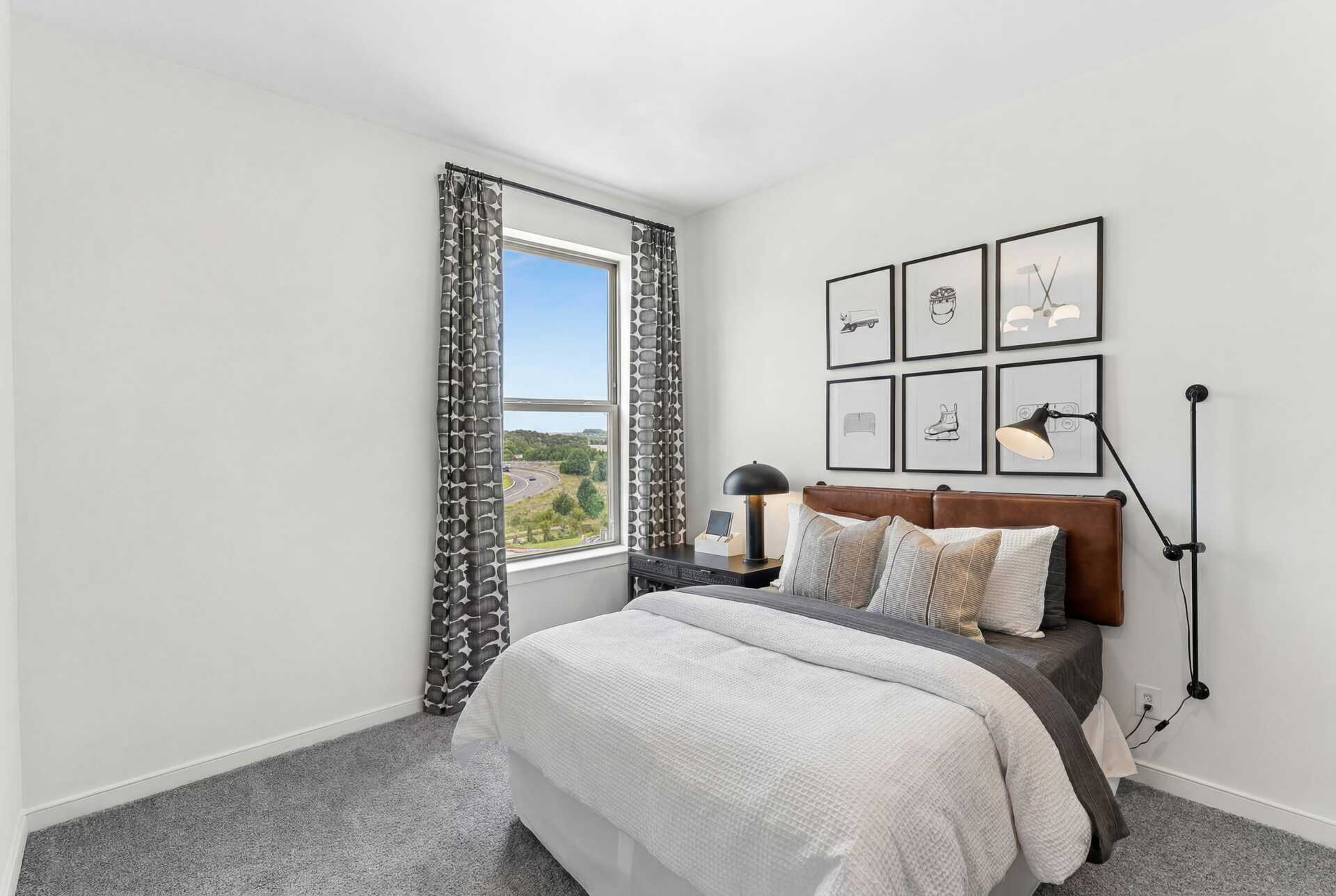 bedroom with carpet windows and queen bed
