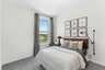 bedroom with carpet windows and queen bed