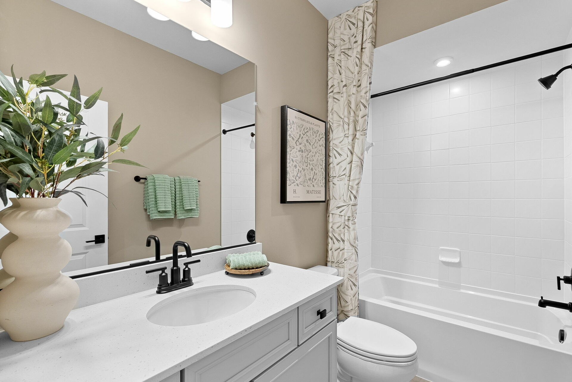 tub and shower with toilet and vanity