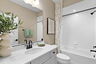 tub and shower with toilet and vanity