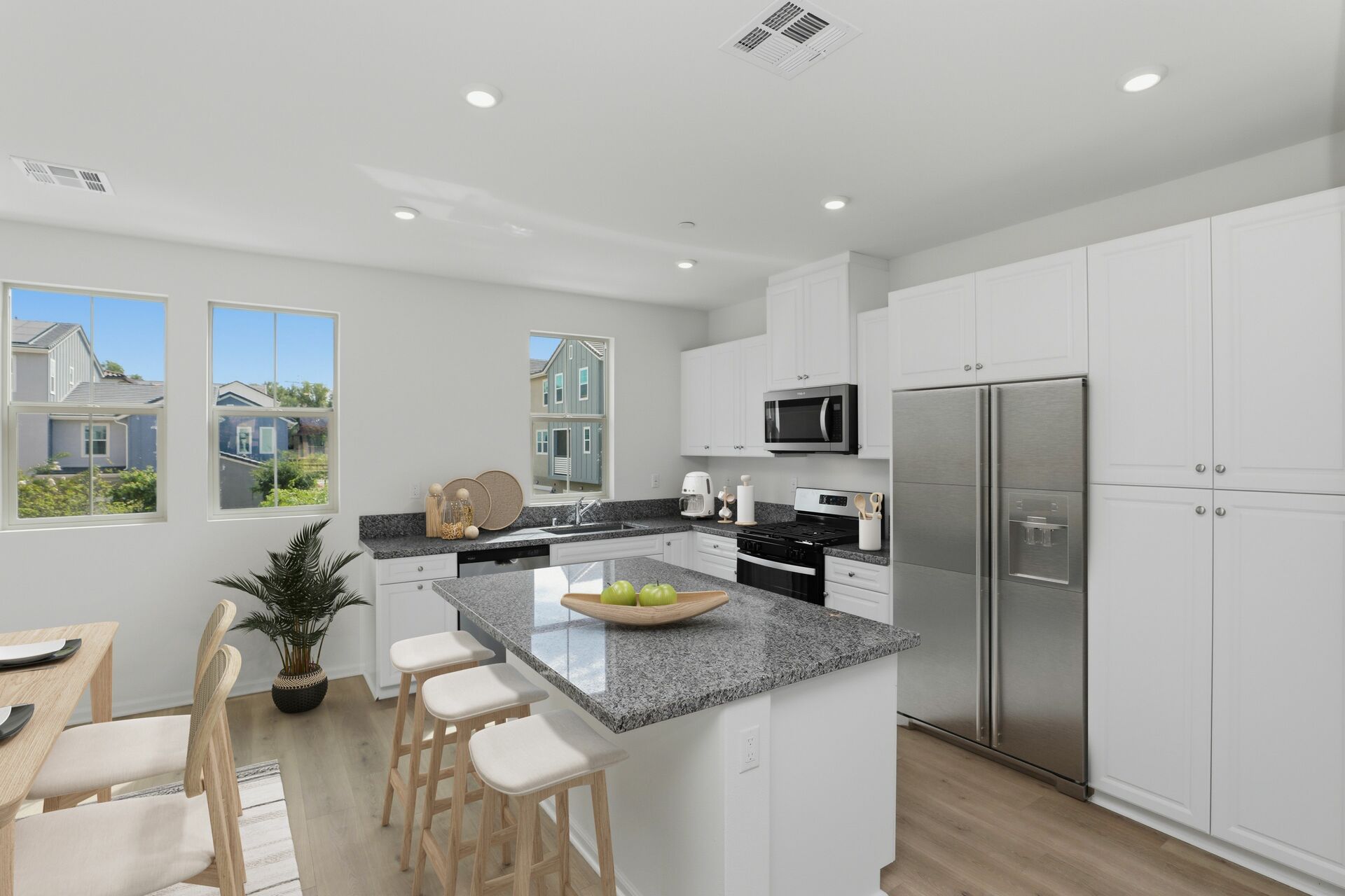 kitchen with large windows and white cabinets